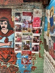 Posters and murals at Santuario del Gauchito Gil in Parque Los Andes, Argentina showcasing local culture and devotion by Wendy Howard