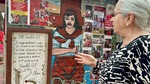 Woman shares stories near the mural of Gauchito Gil at Santuario del Gauchito Gil in Argentina by Wendy Howard