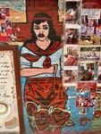 Artwork of a woman at Santuario del Gauchito Gil in Parque Los Andes, Argentina, showcasing local culture and tradition through murals and photographs by Wendy Howard