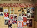 Wall display of memories and tributes at Santuario del Gauchito Gil in Parque Los Andes, Argentina during the afternoon by Wendy Howard