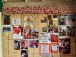 Memorial wall at Santuario del Gauchito Gil in Parque Los Andes, Argentina, featuring photos and messages from visitors and devotees by Wendy Howard