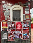 Visitors explore messages and photos at the Santuario del Gauchito Gil in Parque Los Andes, Argentina, reflecting its devotees' history by Wendy Howard