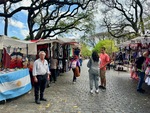 Visitors explore street market stalls in Parque Los Andes, Buenos Aires in a vibrant display of local culture and crafts by Wendy Howard