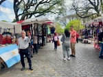 Street market scene in Parque Los Andes, Buenos Aires with vendors and visitors exploring the stalls by Wendy Howard