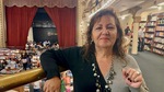 Woman stands at the Anteo Bookstore in Buenos Aires, engaging with visitors as they explore the literary space by Wendy Howard