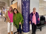 Group of three women pose in front of university signage at Universidad Catolica Argentina in Puerto Madero, Buenos Aires by Wendy Howard