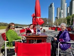 Friends enjoying lunch at Puerto Madero by Laguna de los Coipos on a sunny day in Buenos Aires by Wendy Howard
