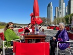 Lunch time gathering by the lake Laguna de los Coipos in Puerto Madero, Buenos Aires with friends enjoying food and conversation by Wendy Howard