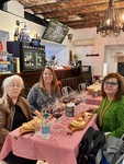 Ladies enjoying a meal and CHE Malbec wine at the Edificio San Alberto Magno in Puerto Madero, Buenos Aires by Wendy Howard