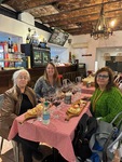 Ladies enjoying a meal at a winery in Edificio San Alberto Magno with CHE Malbec wine in Puerto Madero, Buenos Aires by Wendy Howard