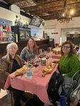 Ladies enjoying a meal and CHE Malbec wine at a vinoteca in Edificio San Alberto Magno, Buenos Aires, Argentina by Wendy Howard