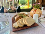 Guests enjoy fresh bread at Lamadrid Estate Wines with views of the gardens in Mendoza, Argentina during a dining experience by Wendy Howard