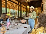 Visitors enjoying a wine tasting experience at Lamadrid Estate Wines in Mendoza, Argentina with a guide explaining the wines by Wendy Howard