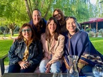 Friends enjoy time together at Lamadrid Estate Wines in Mendoza, Argentina on a sunny afternoon by Wendy Howard