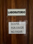 Sign on a door indicating a laboratory at Lamadrid Estate Wines in Mendoza Argentina with instructions for knocking before entering by Wendy Howard