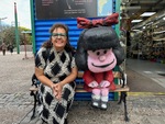 Exploring Caminito in Buenos Aires with a colorful figure and a cheerful visitor by Wendy Howard