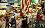 Kids standing for Pledge of Allegiance by iStockPhoto N/A