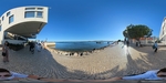 Coastal walkway in Lisbon with people and vibrant skies by Wendy Howard