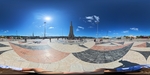 Visitors explore the Calçada Portuguesa patterns and the monument in the large square in Lisbon under clear blue skies by Wendy Howard