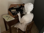 Art installation at Museu do Aljube shows figure using a vintage typewriter in Lisbon by Wendy Howard