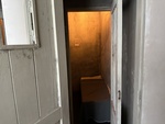 View into a small, dimly lit room in Museu do Aljube, a site of resistance and freedom in Lisbon, Portugal by Wendy Howard