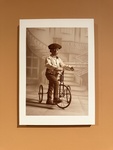 Child on a vintage bicycle in a Lisbon museum setting by Wendy Howard