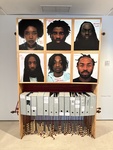 Artwork display featuring portraits and archival boxes at a museum in Lisbon by Wendy Howard