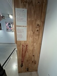 Wooden wall installation featuring text and artistic elements at a Lisbon art gallery by Wendy Howard