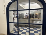 Bakery workers prepare pastries in a Lisbon kitchen with tiled floors by Wendy Howard