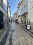 Walking along the narrow cobblestone streets of Alfama neighborhood in Lisbon, Portugal by Wendy Howard