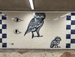 Mural of owls in a Lisbon subway station with blue and white tile work by Wendy Howard