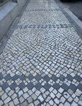 Cobblestone sidewalk design in Lisbon showcasing traditional Portuguese pavement patterns by Wendy Howard