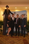 Stilt walker, guests at step and repeat C by Rosen College of Hospitality Management