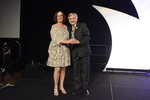 Kathie Canning receives award from Dr. Pizam 2 by Rosen College of Hospitality Management