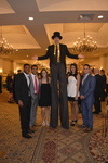 Stilt walker and guests at Cocktail Hour 2 by Rosen College of Hospitality Management