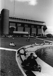Library - students sit in front of the Reflecting Pond
