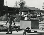 Dormitories - smiling student walking by construction